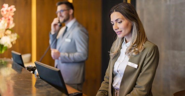 Hotel-staff-making-calls-and-looking-at-online-bookings