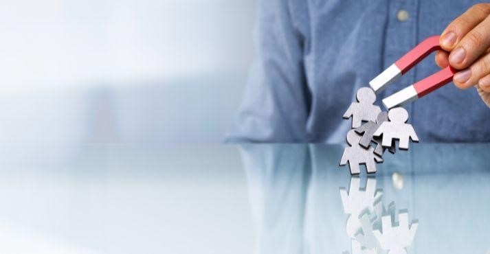 Man-using-magnet-to-attract-metal-figures-leads