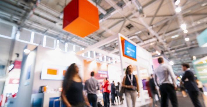 Trade-show-participants-looking-at-stalls