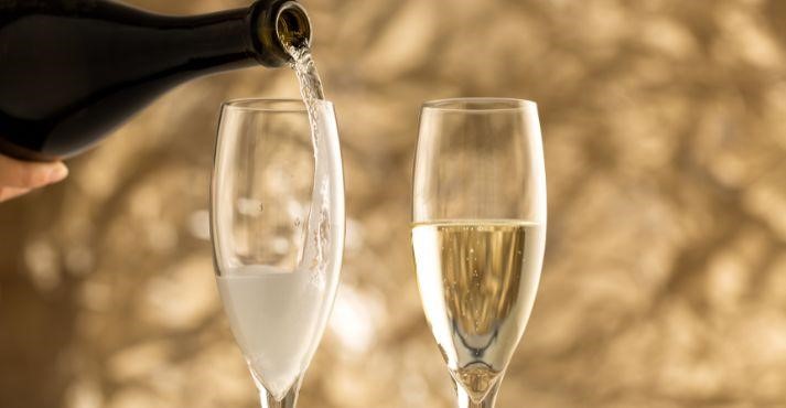 Sparkling-wine-being-poured-into-wine-glasses Sparkling-wine-being-poured-into-wine-glasses