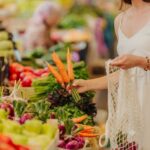 Person-buying-fresh-local-carrots-at-a-food-market
