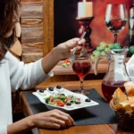 solo-female-diner-enjoying-a-fresh-greek-salad-with-wine