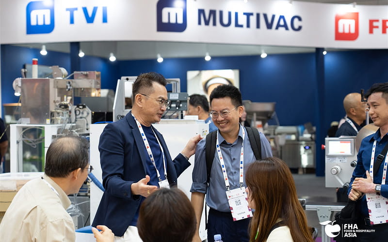 Industry professionals discussing food manufacturing technology at exhibition event